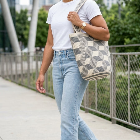 Large handwoven Colombian mochilón tote packed for travel with jeans and a t-shirt 